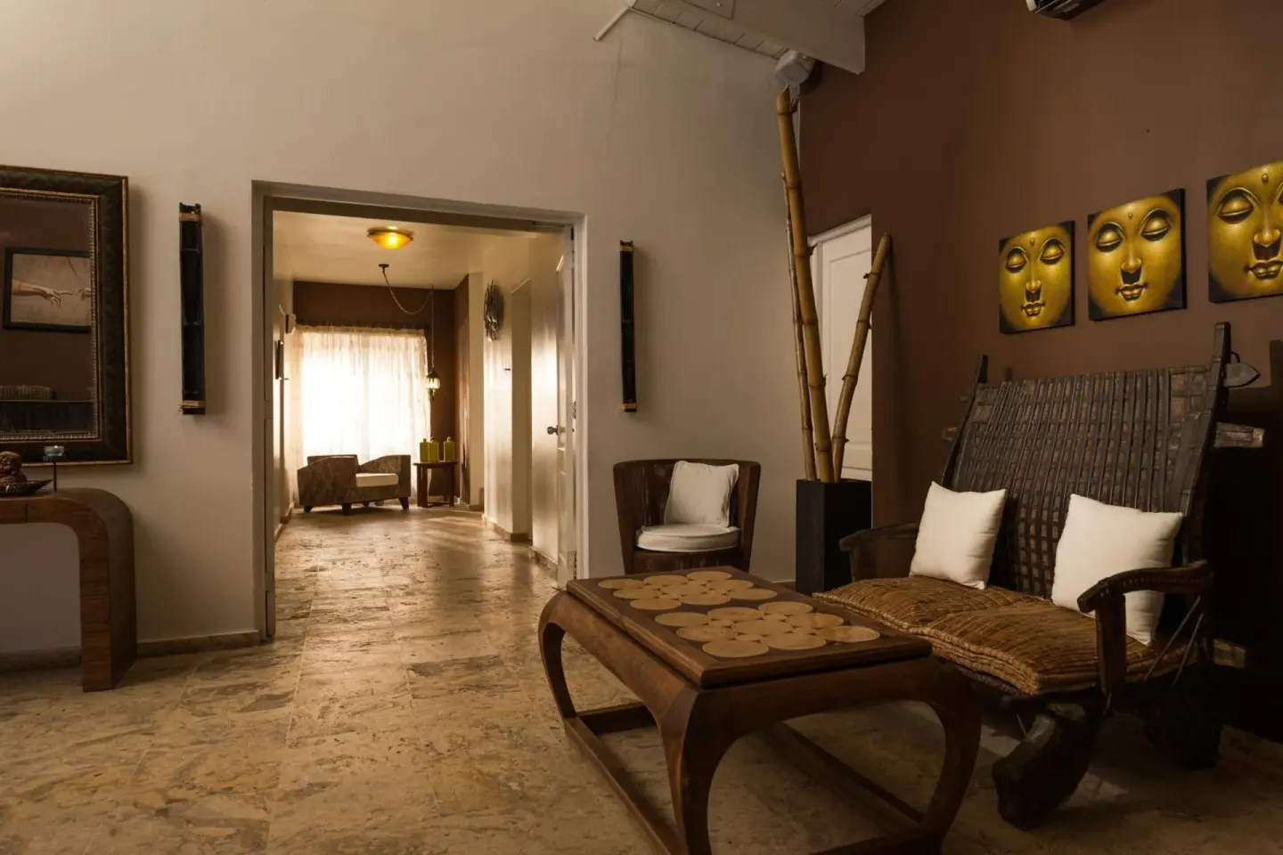 Quiet lounge seating with carved wood furniture at BlueBay Villas Doradas.