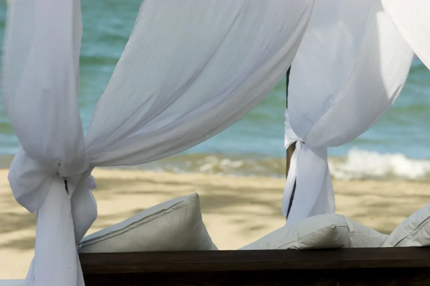 Close-up of white beach cabana curtains at BlueBay Villas Doradas.