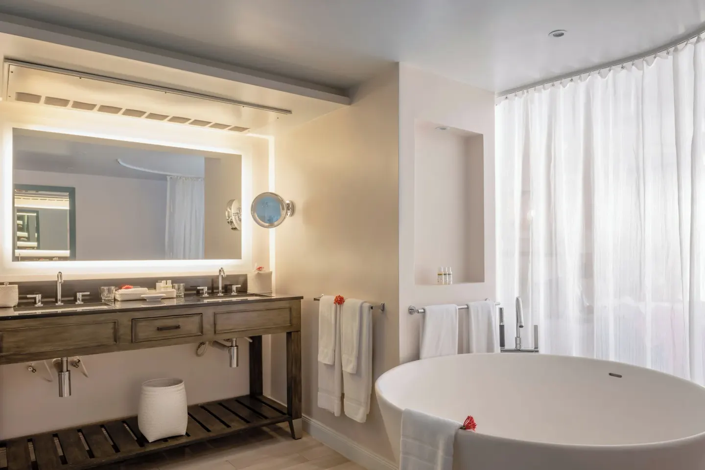 Double vanity and oval soaking tub in a bathroom at BodyHoliday.