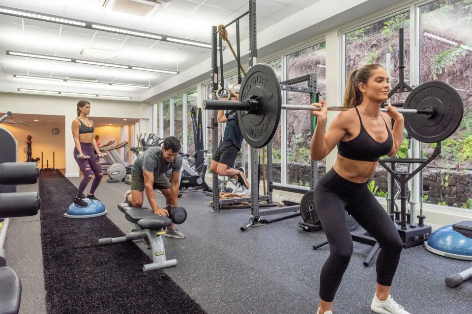 Guests train with barbells, balance equipment and benches in the gym at BodyHoliday.