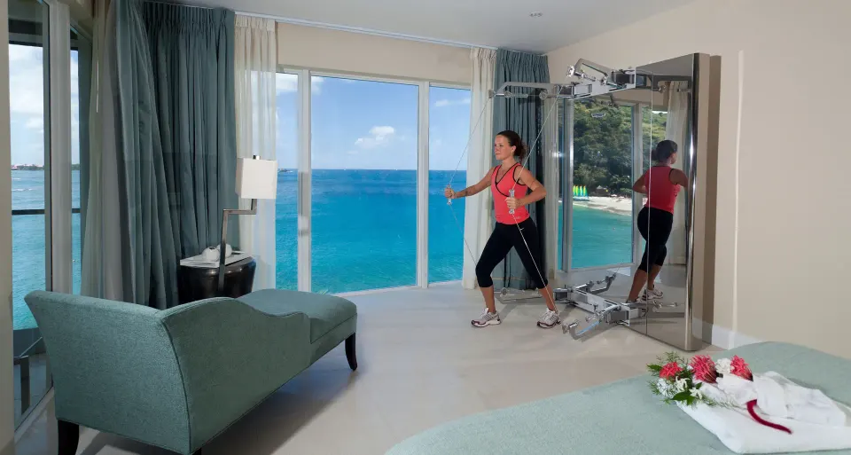 In-room cable exercise equipment beside sea-view windows at BodyHoliday.