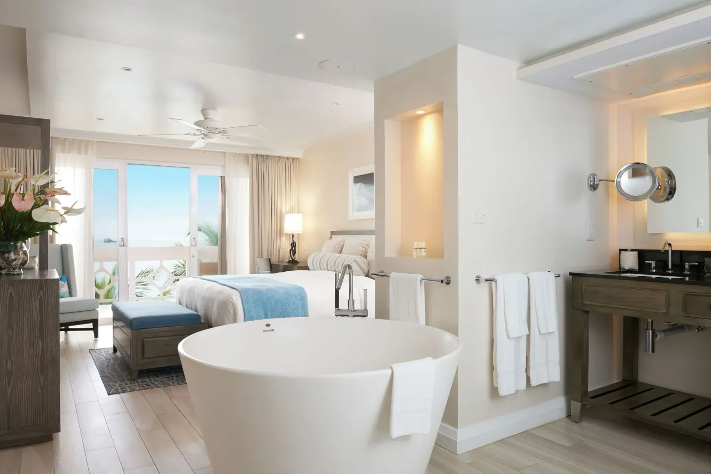 Grand Room Oceanfront bed, soaking tub, vanity and balcony view at BodyHoliday.