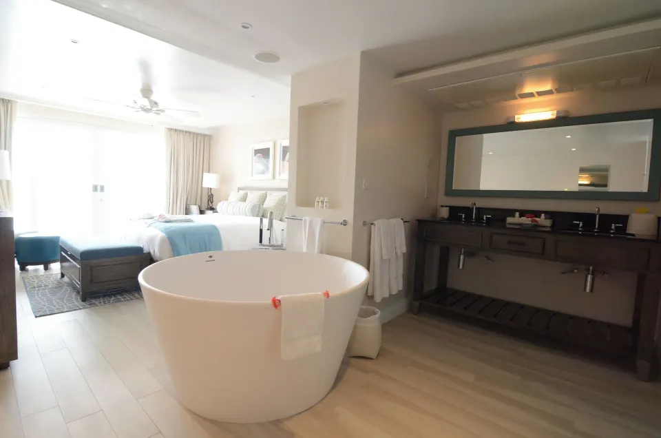 Grand Room Oceanfront soaking tub and double vanity beside the bed at BodyHoliday.