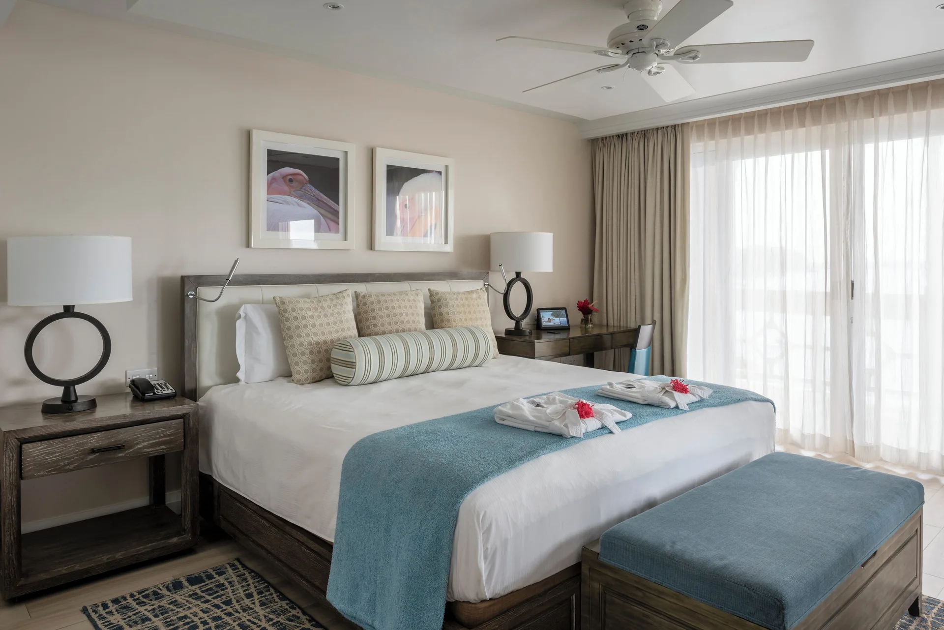 Junior Studio Suite Oceanfront king bed and balcony doors at BodyHoliday.