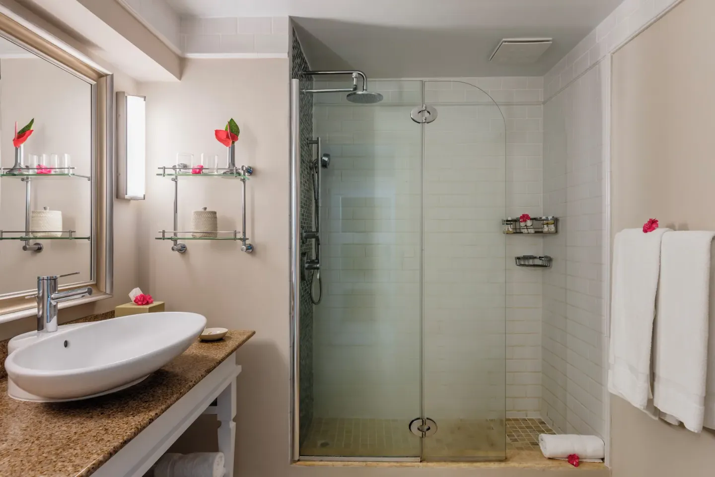 Garden View room bathroom at BodyHoliday with glass shower, towels, and vanity sink.