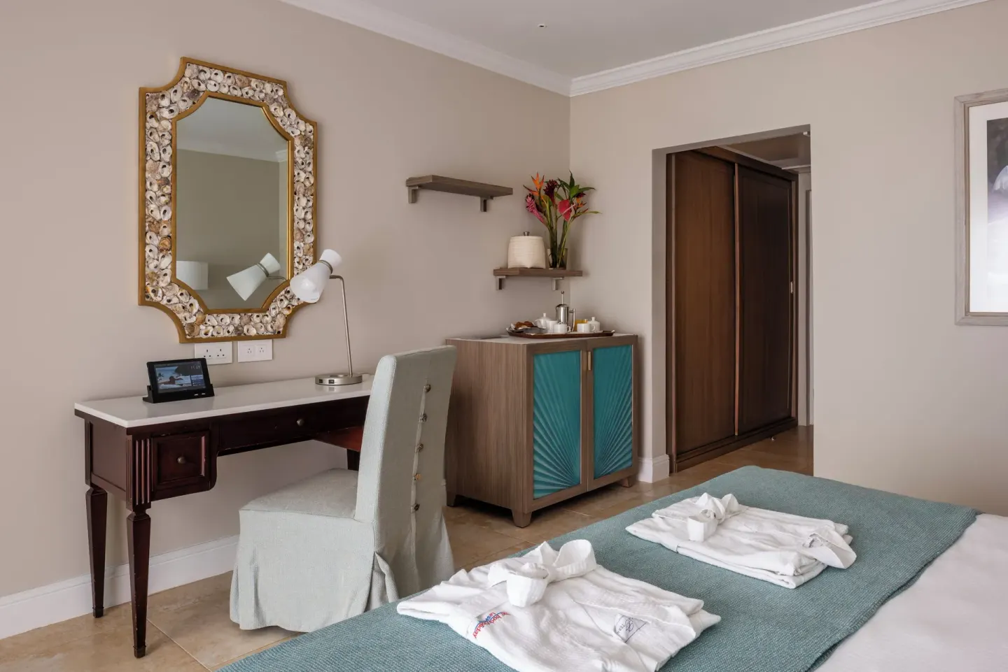 Garden View room at BodyHoliday with twin bed, writing desk, cabinet, and wardrobe.