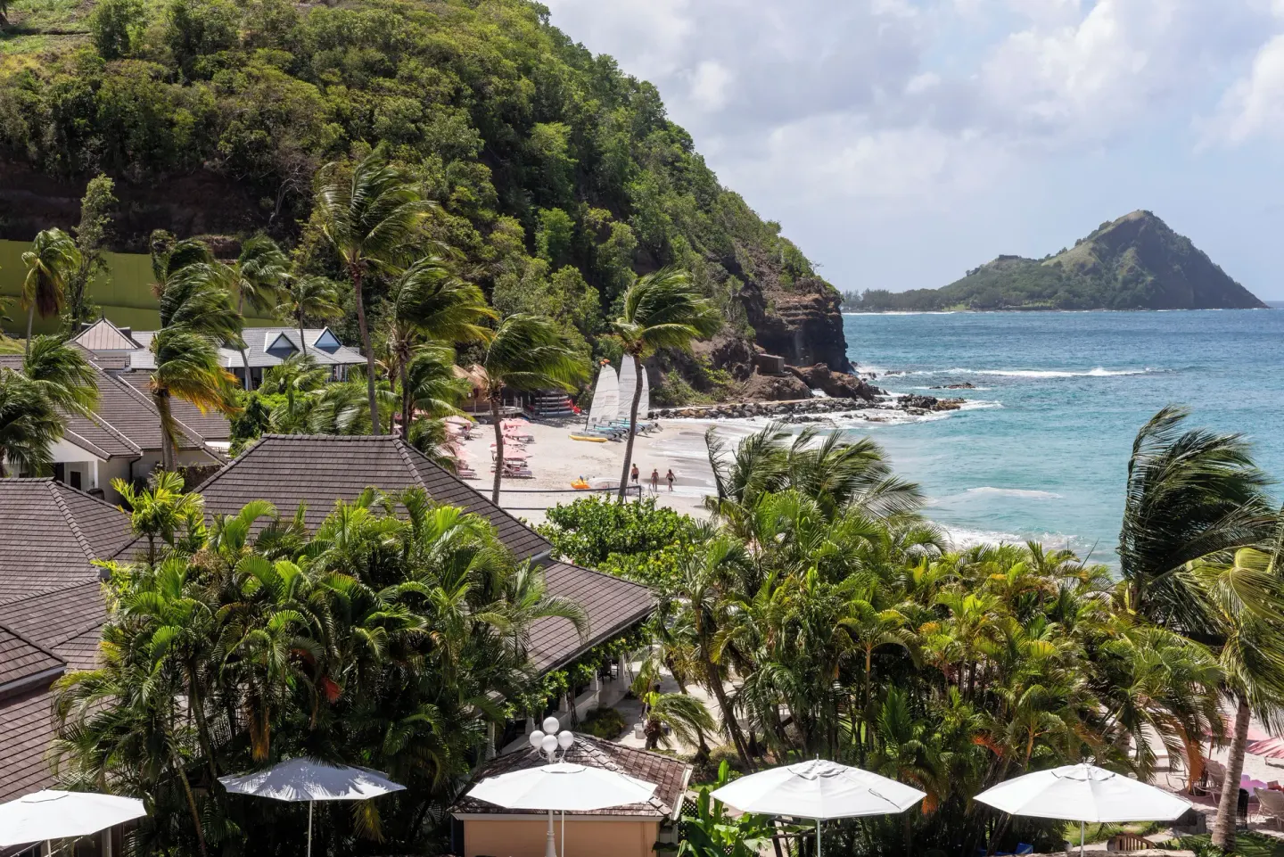 Ocean View Room outlook over beach, palms, rooftops, and bay at BodyHoliday.