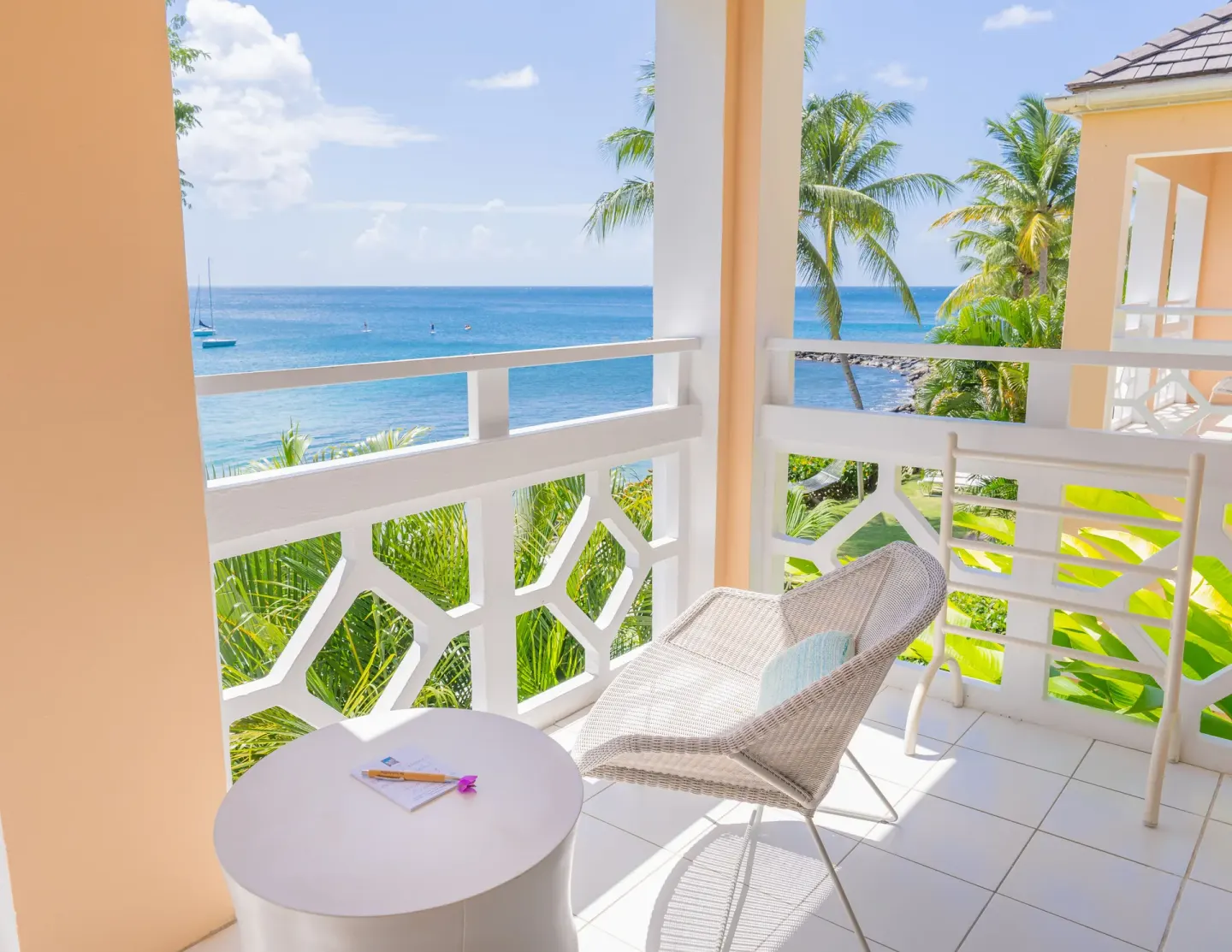 Oceanfront room balcony with wicker chair and sea view at BodyHoliday.