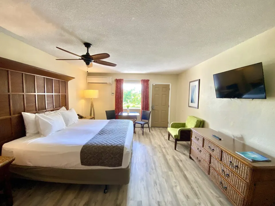 Beachfront patio guest room with king bed and seating at Bolongo Bay Beach Resort.