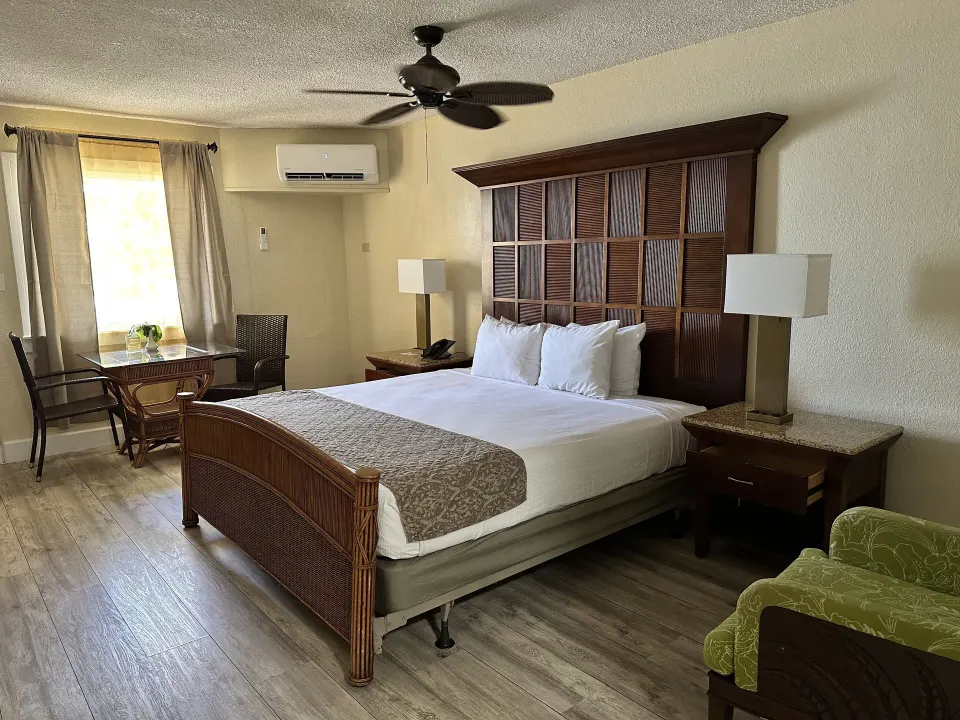 King bed room with window table and green chair at Bolongo Bay Beach Resort.
