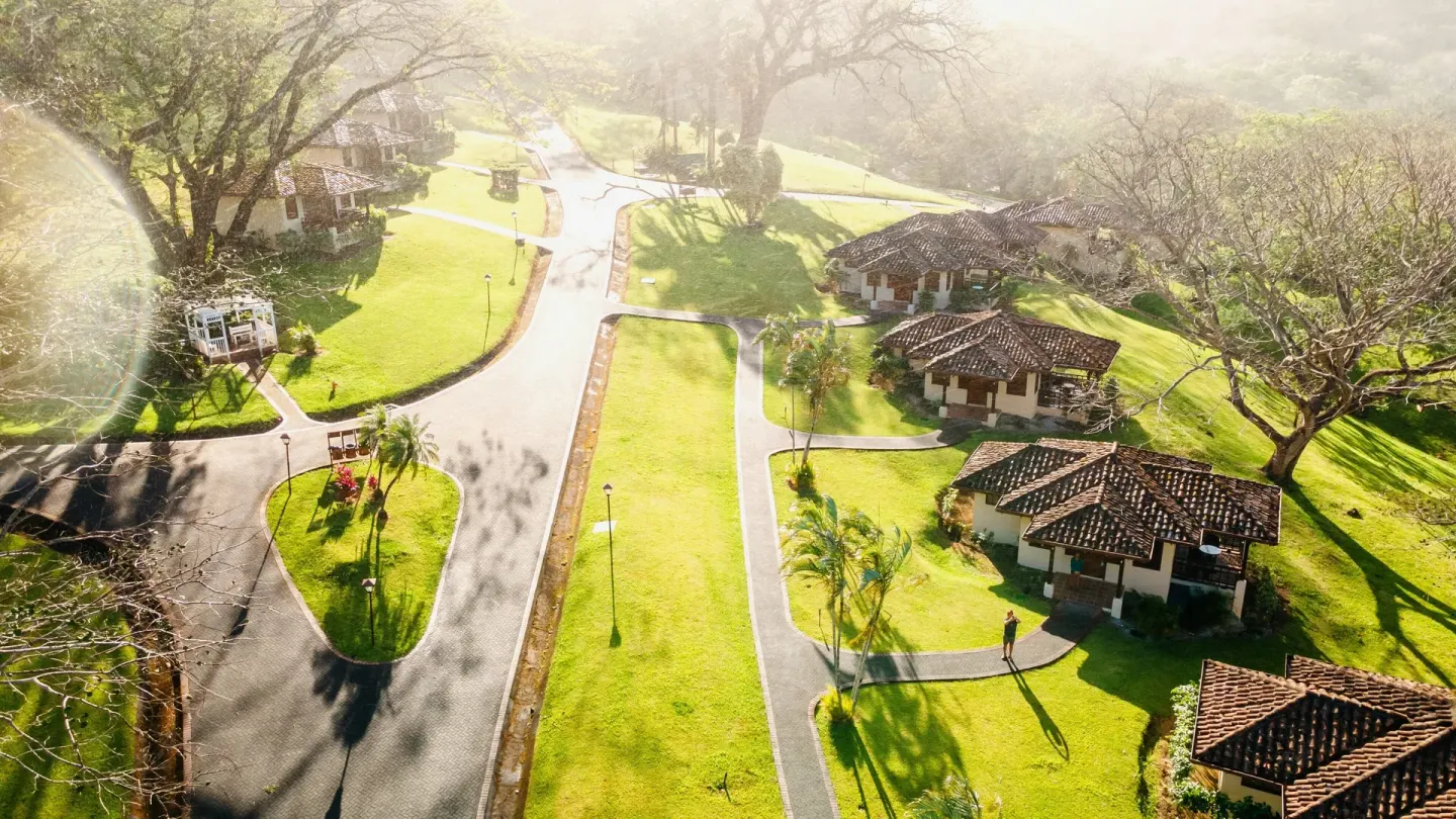 Aerial view of lawns, roads, and guest buildings at Borinquen Thermal Resort.