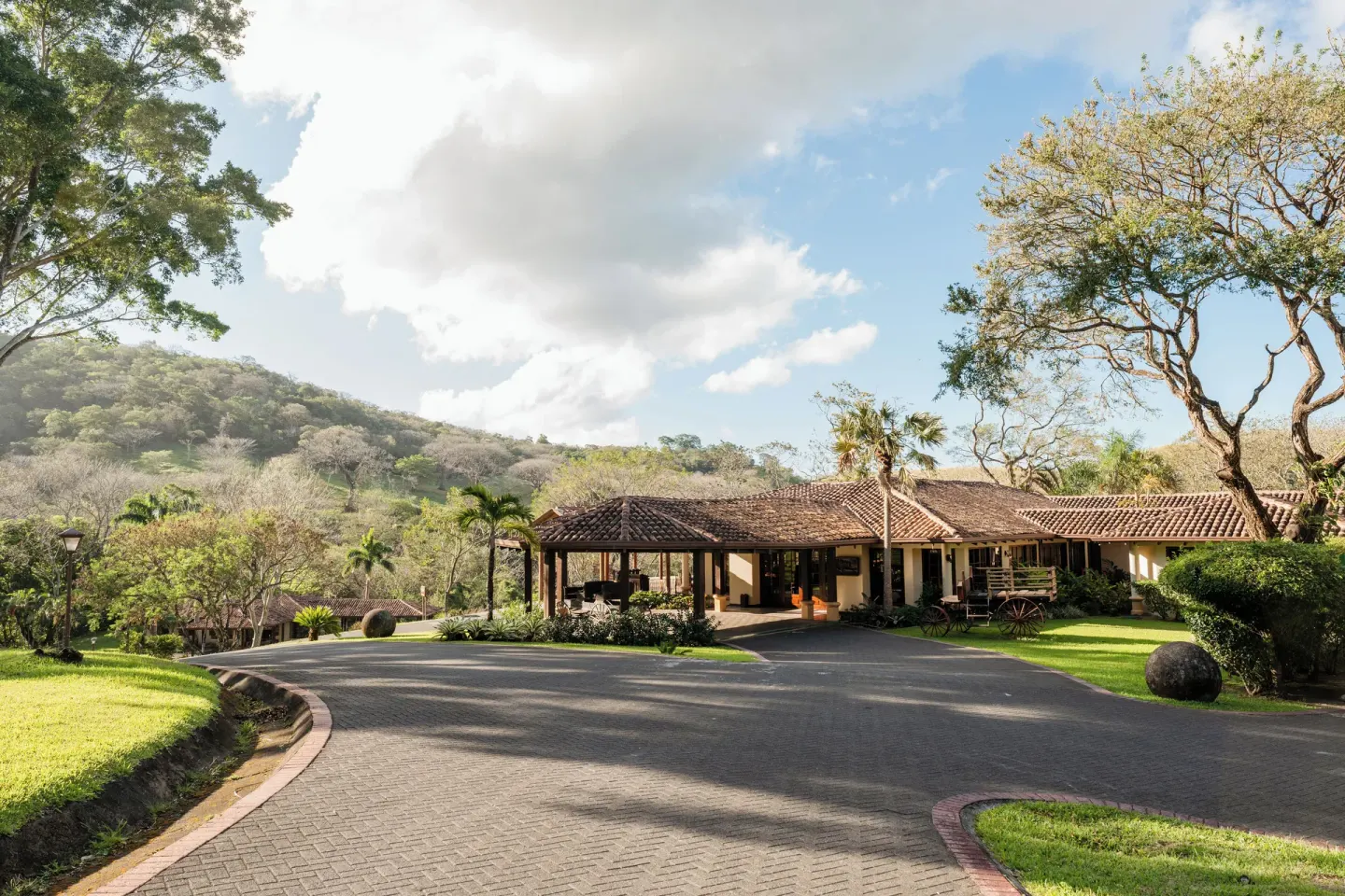 Tile-roofed resort building and driveway in the hills at Borinquen Thermal Resort.