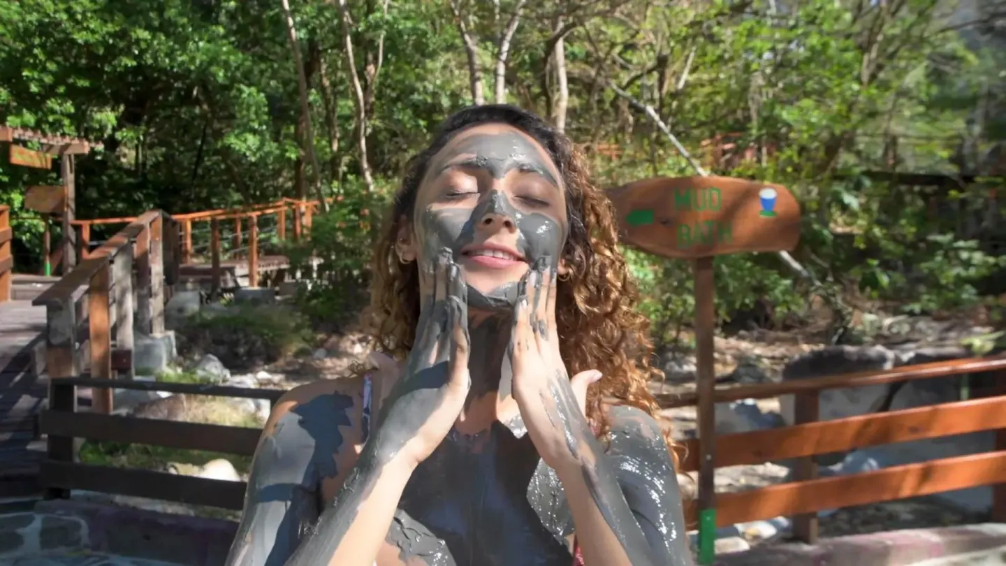 Guest applying mineral mud beside the mud bath area at Borinquen Thermal Resort.