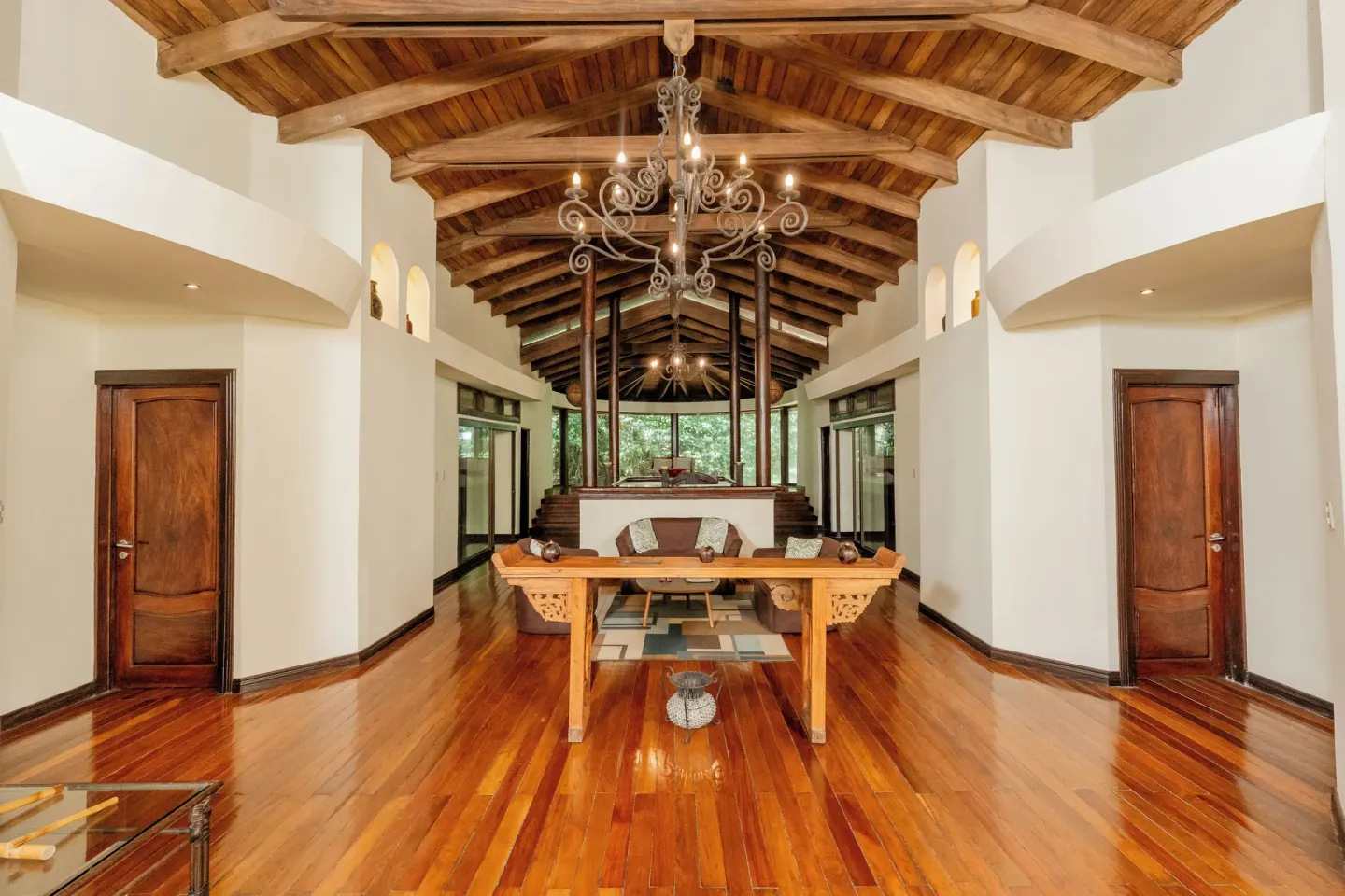 High-ceiling lounge with wood beams and chandeliers at Borinquen Thermal Resort.