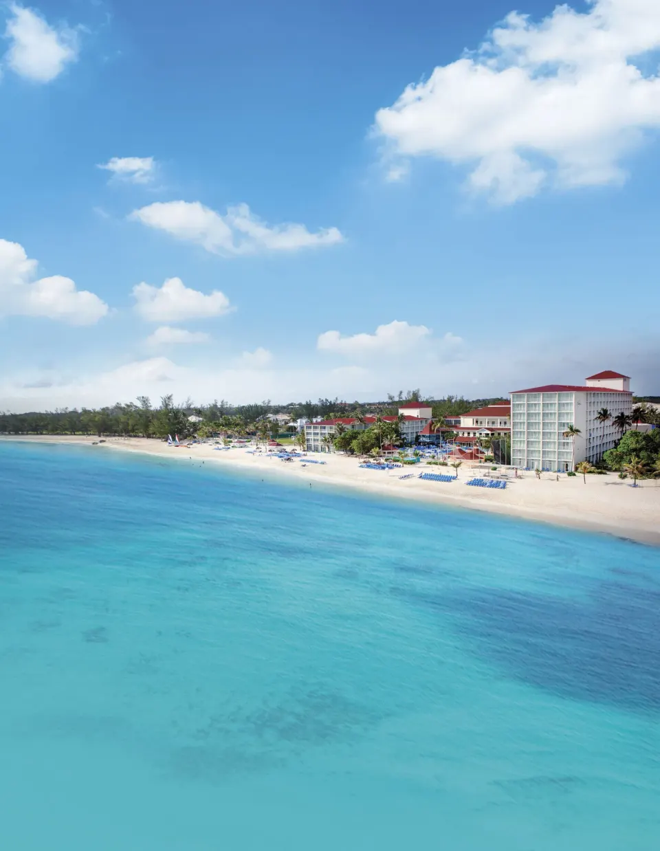 Aerial view of the beach and turquoise water at Breezes Resort Bahamas.