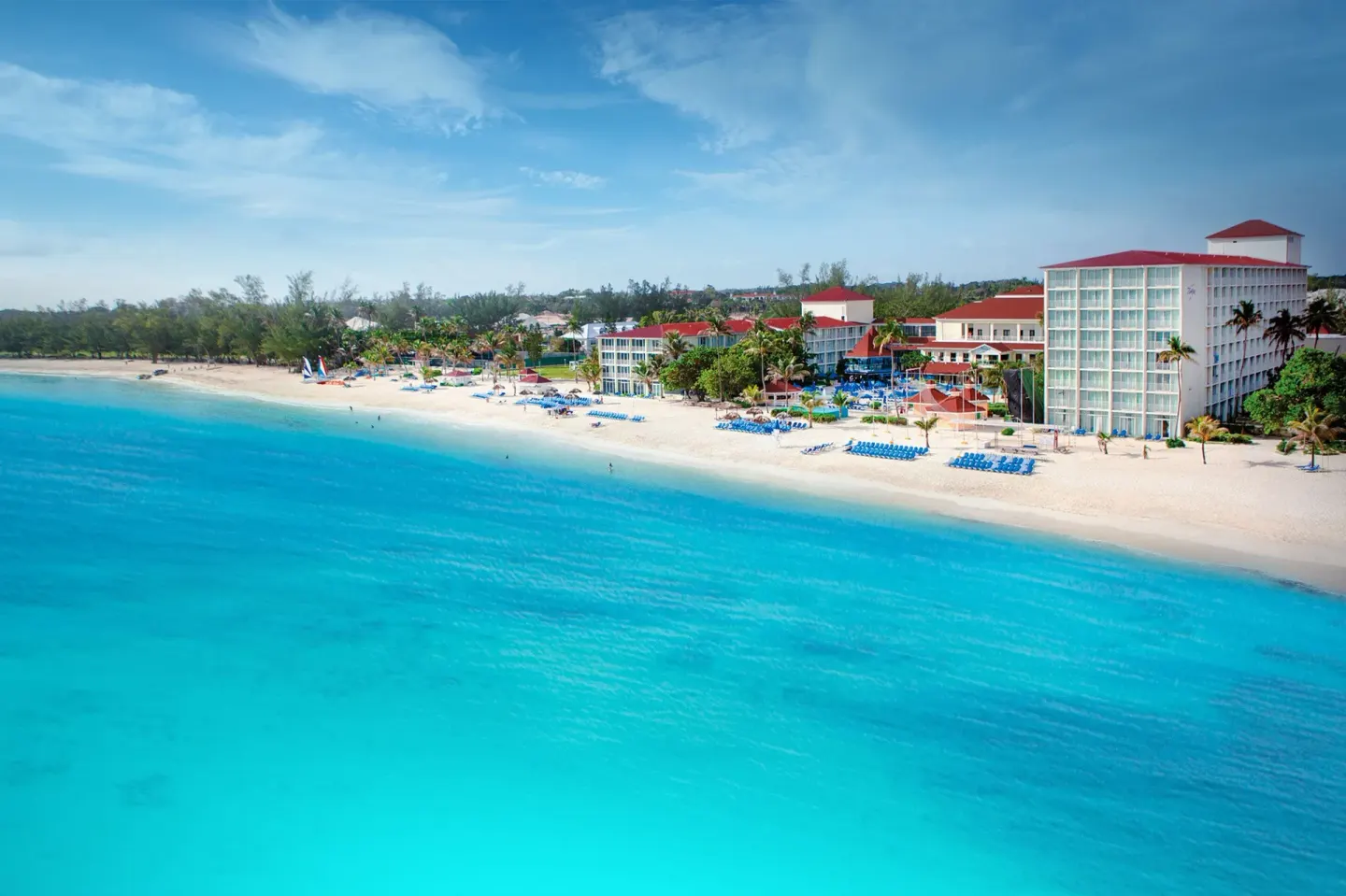 Aerial view of the beach and turquoise water at Breezes Resort Bahamas.