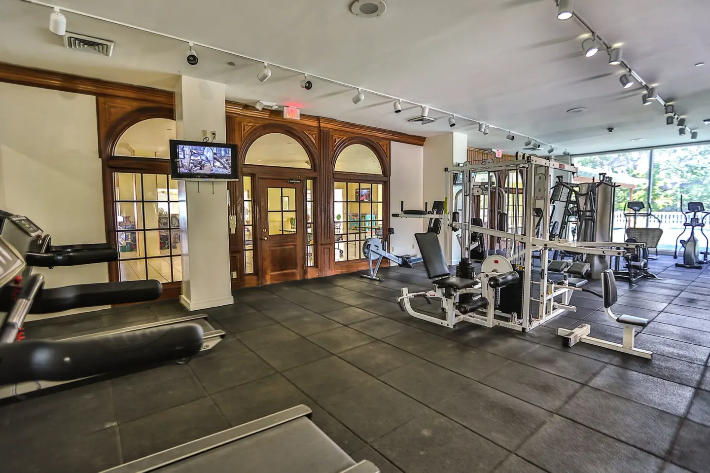 Fitness room with treadmills, weight machines, and rubber flooring at Breezes Resort Bahamas.