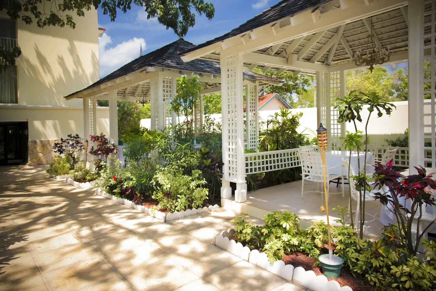 Garden terrace with white gazebos and outdoor tables at Breezes Resort Bahamas.