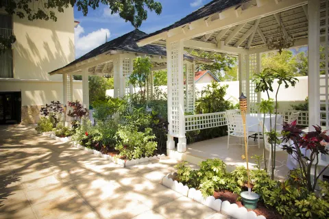 Garden terrace with white gazebos and outdoor tables at Breezes Resort Bahamas.