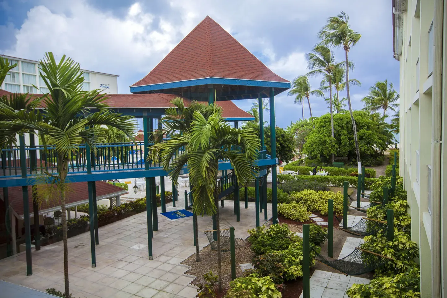 Elevated walkways, palms, and gardens at Breezes Resort Bahamas.