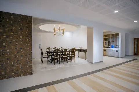 Lobby-adjacent seating area with chandelier and refreshment station at Breezes Resort Bahamas.