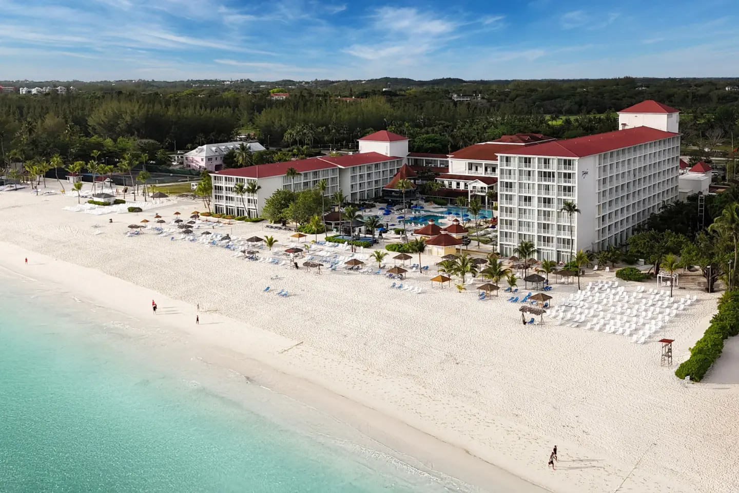 Wide aerial view of the beachfront buildings and white sand at Breezes Resort Bahamas.