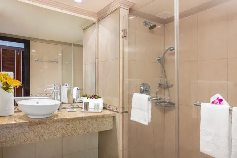 Classic Room bathroom with vessel sink and glass shower at Breezes Resort Bahamas.