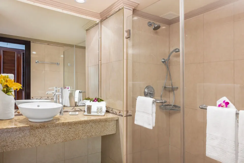 Classic Room bathroom with vessel sink and glass shower at Breezes Resort Bahamas.
