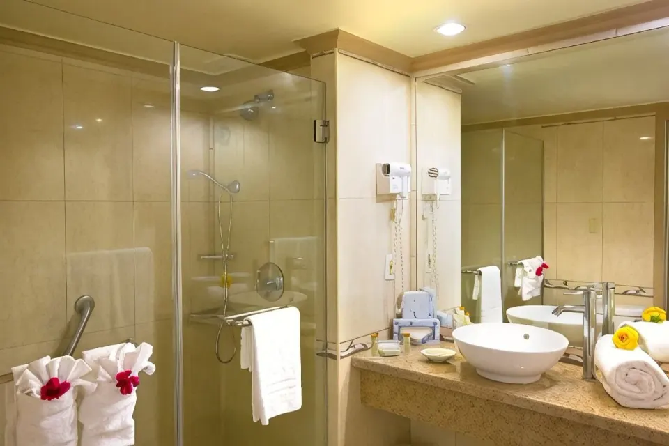 Classic Room bathroom with glass shower and vanity at Breezes Resort Bahamas.
