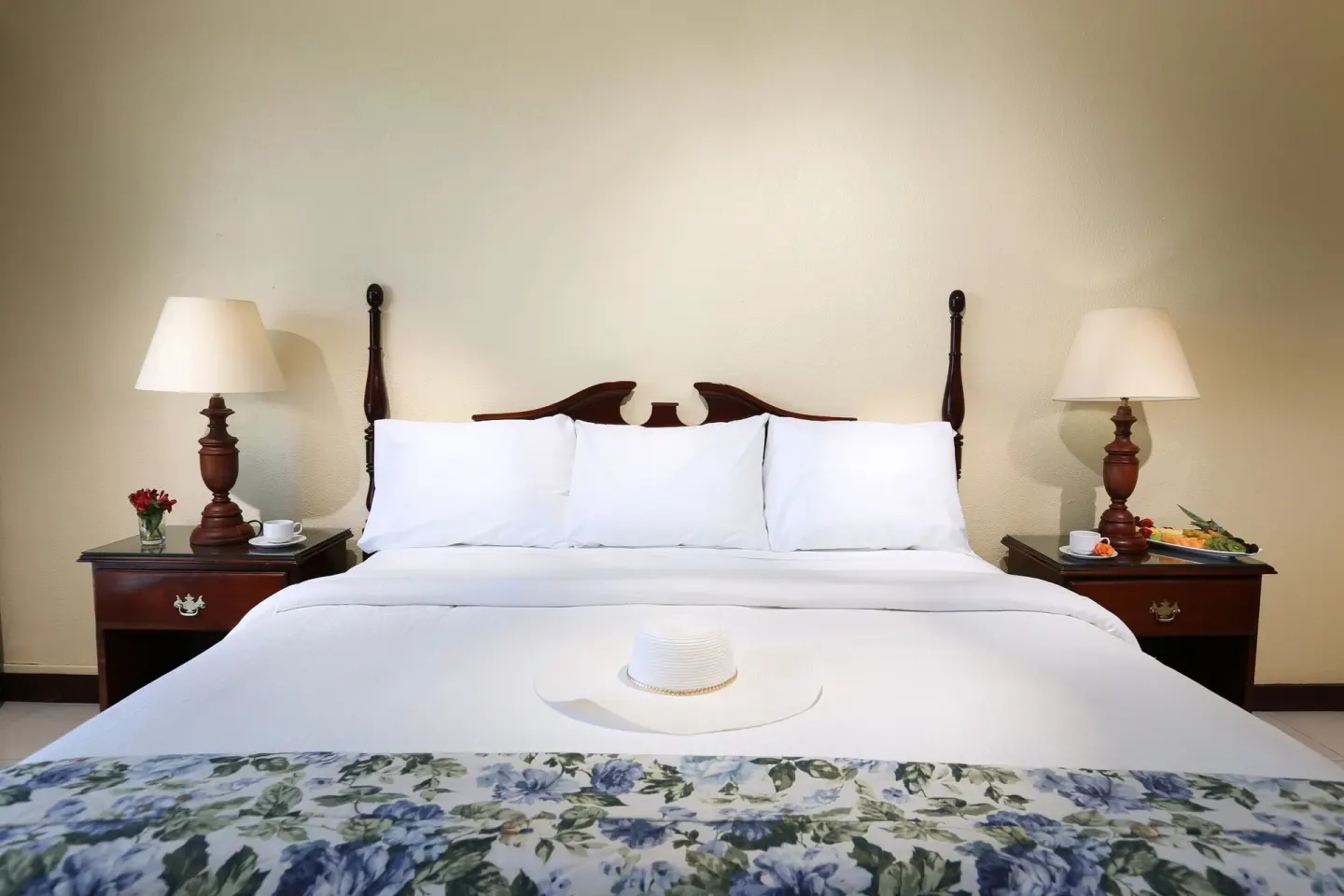 Classic Room king bed with bedside tables and lamps at Breezes Resort Bahamas.