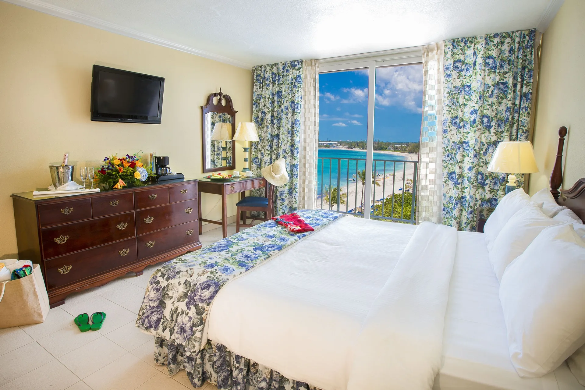 Partial Ocean View Room with king bed and balcony view at Breezes Resort Bahamas.