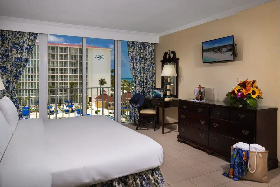 Partial Ocean View Room with king bed and resort-facing balcony at Breezes Resort Bahamas.