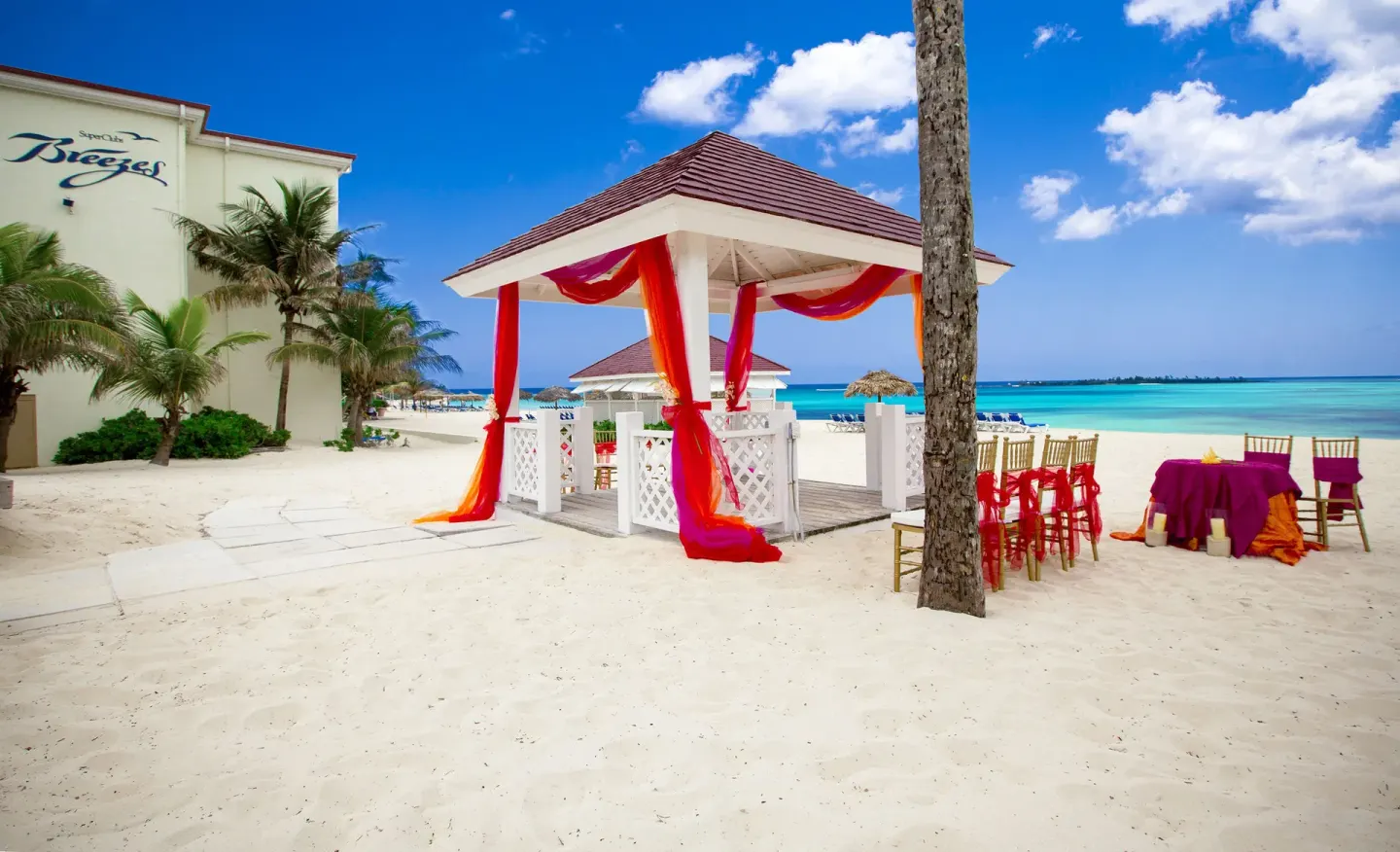 Beach wedding setup with a draped gazebo at Breezes Resort Bahamas.