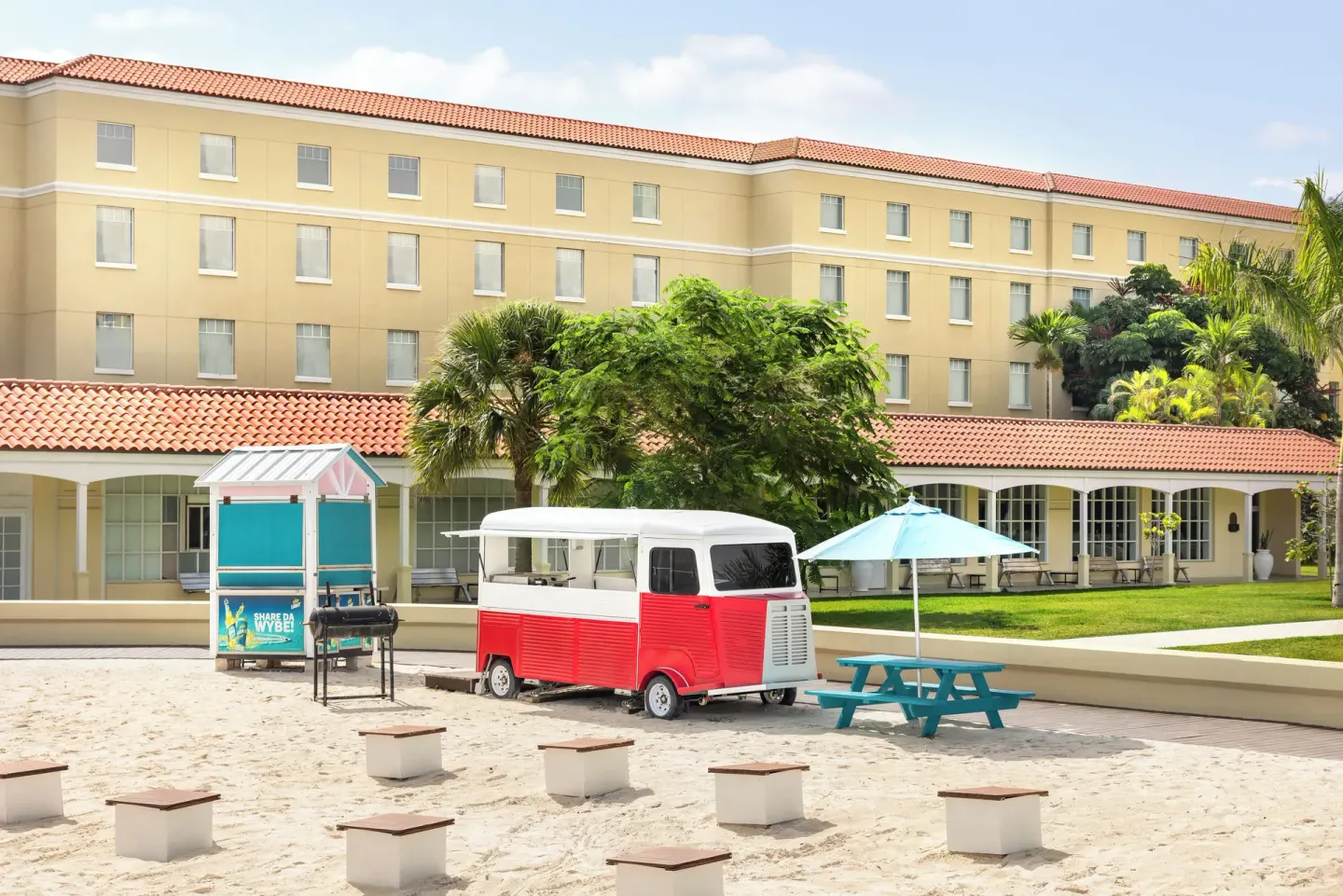 Beach courtyard with food carts, umbrellas, and hotel exterior at British Colonial Nassau.