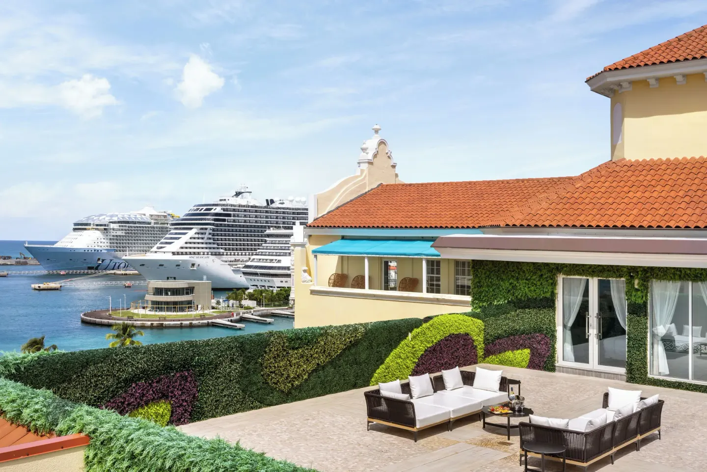 Harbor terrace with lounge seating and cruise ships near British Colonial Nassau.
