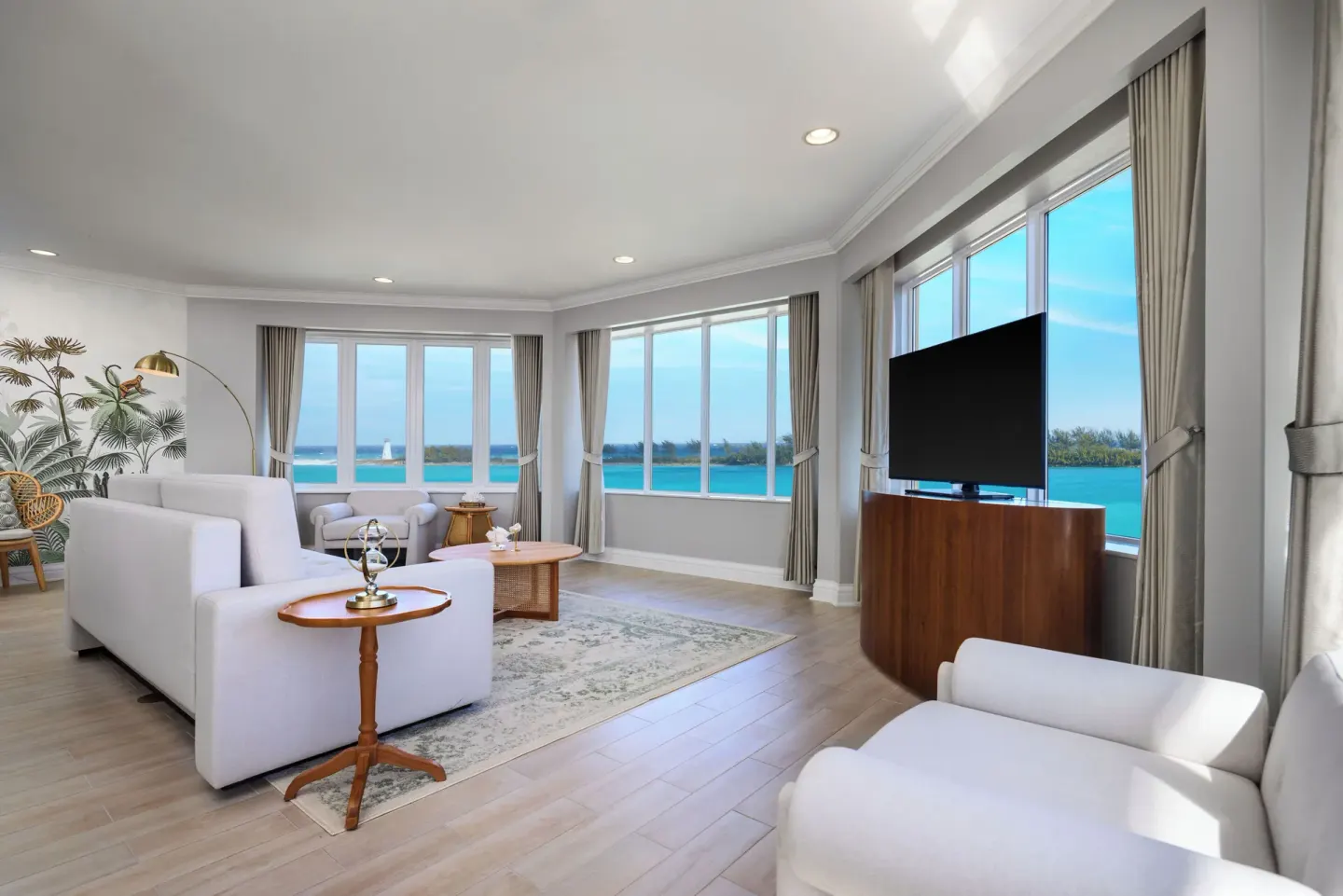 Harbor-view living room with white seating and TV at British Colonial Nassau.