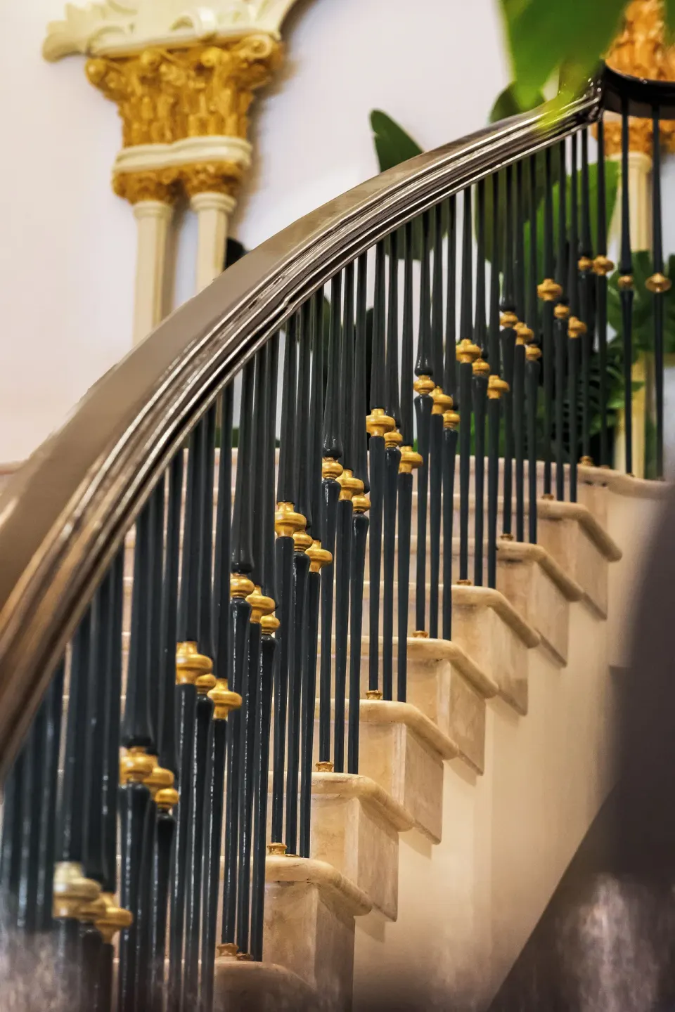 Ornate staircase railing and marble steps inside British Colonial Nassau.