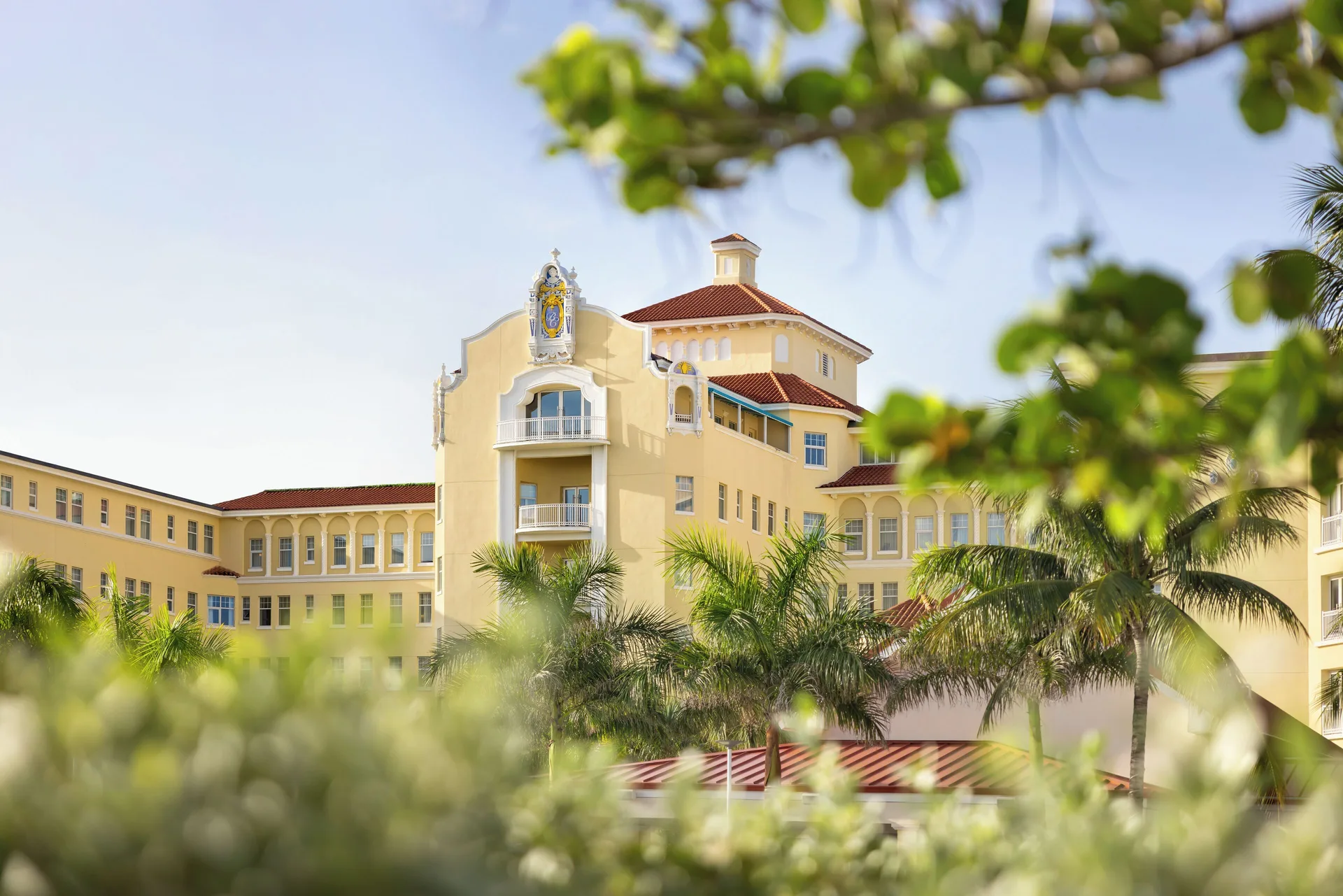 Yellow resort facade framed by tropical greenery at British Colonial Nassau.