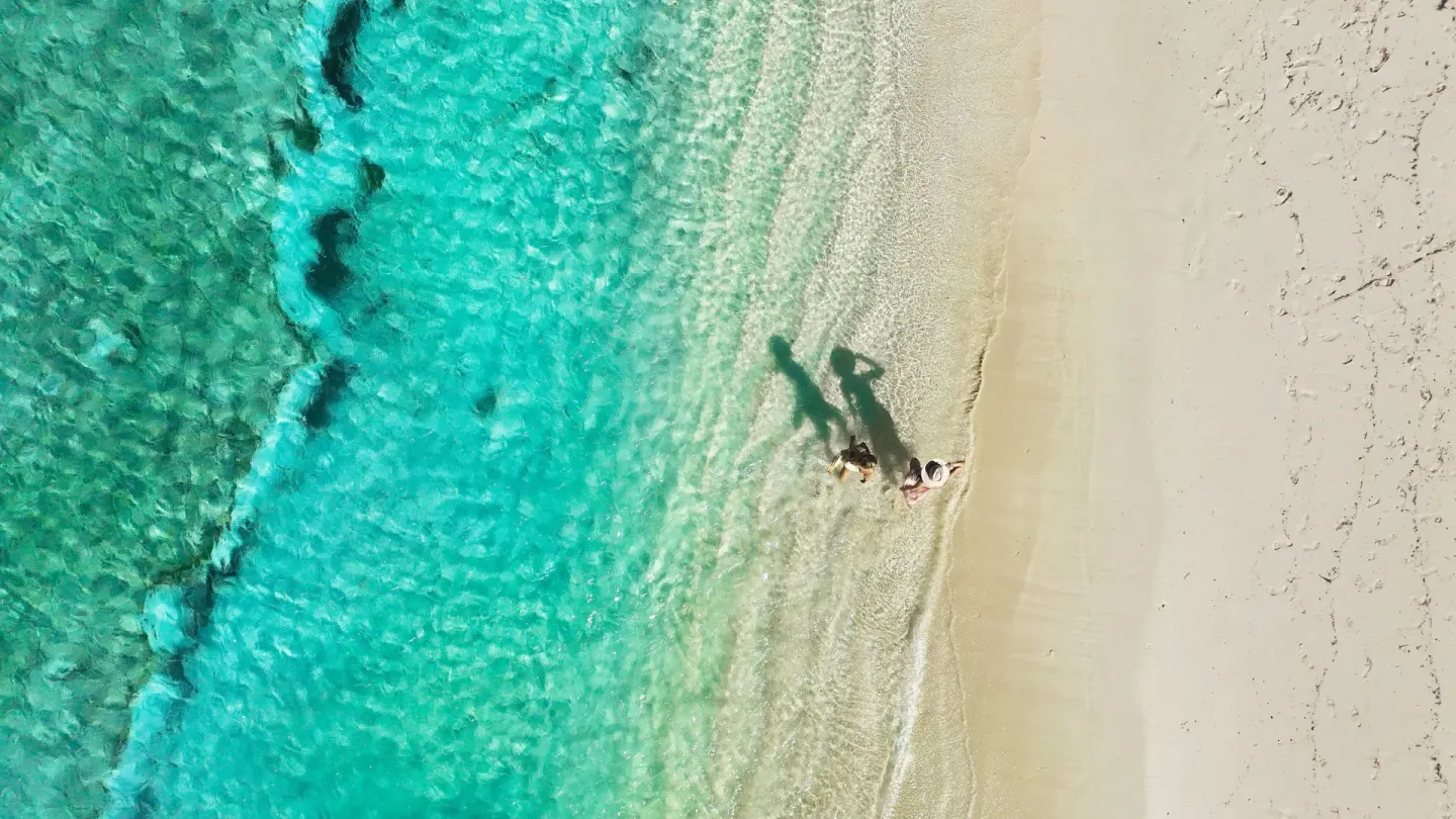 Aerial view of clear turquoise water and sandy beach at British Colonial Nassau.