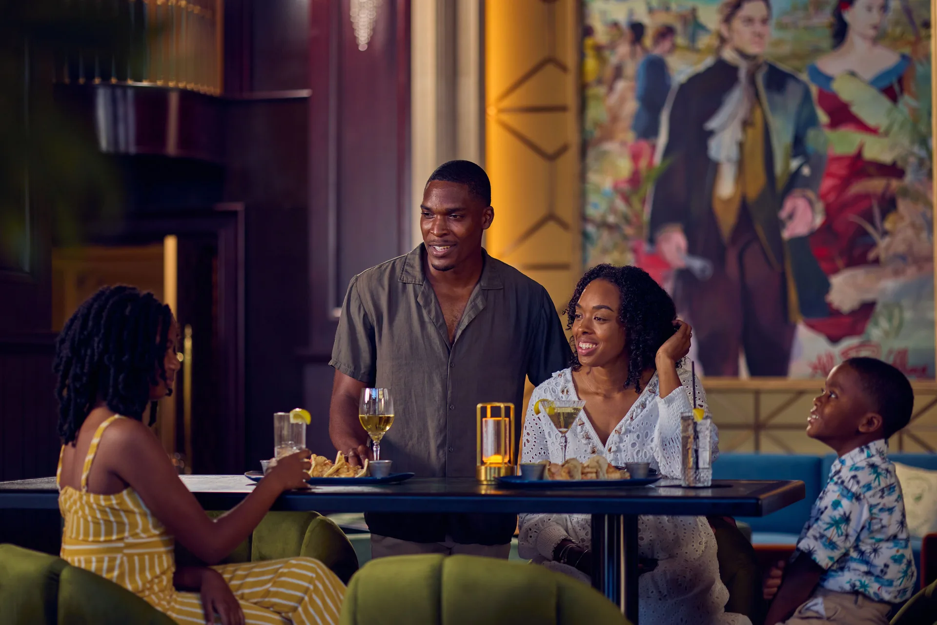Family seated with drinks and plates in a lounge at British Colonial Nassau.
