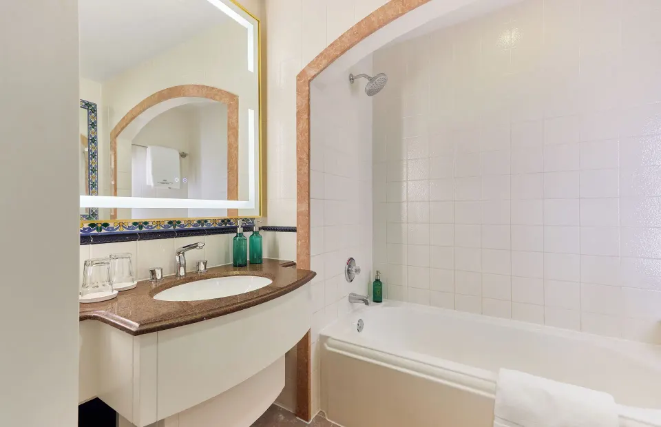 City View Suite bathroom with tub, shower and vanity at British Colonial Nassau.