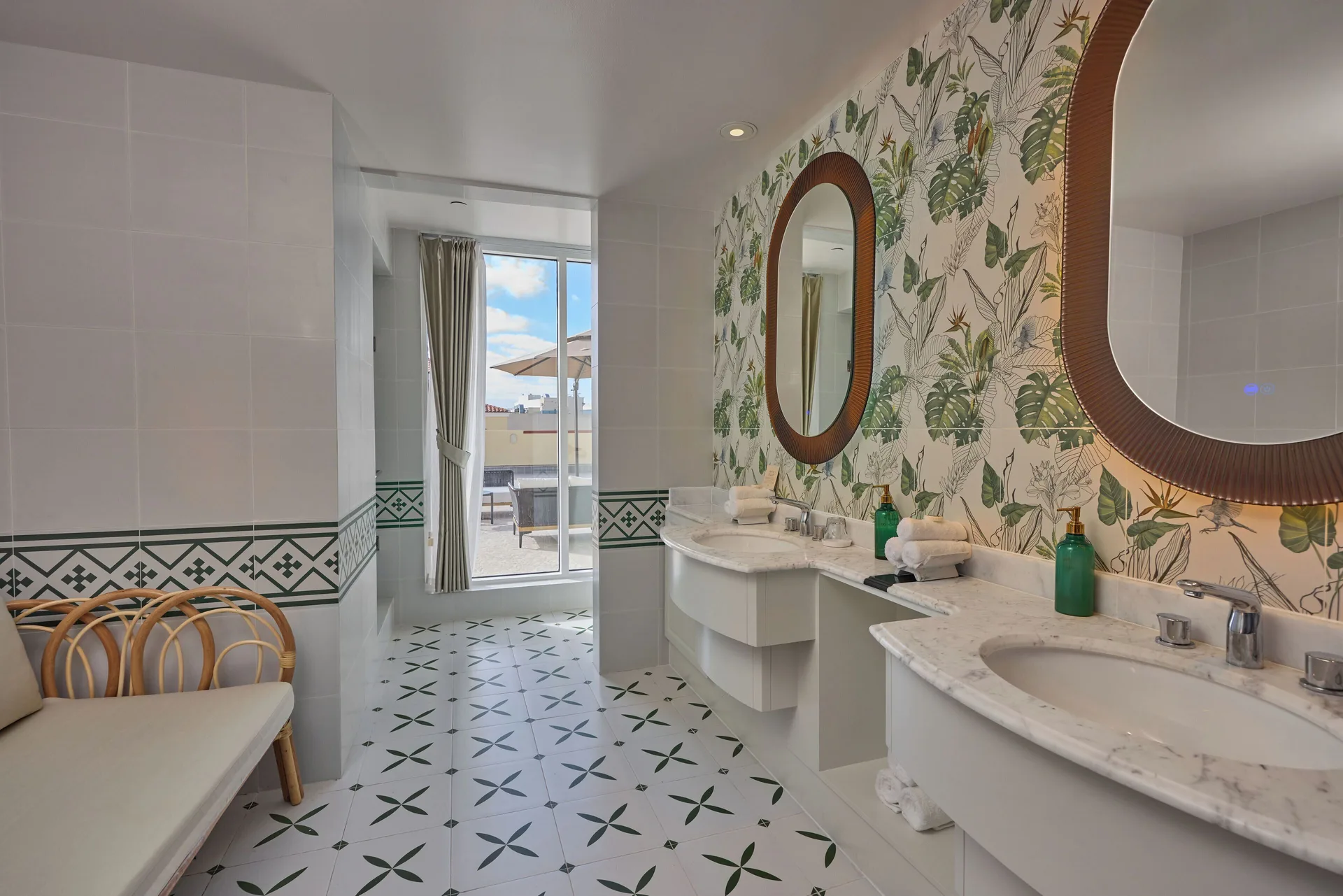 Premium Room bathroom with double sinks and terrace door at British Colonial Nassau.
