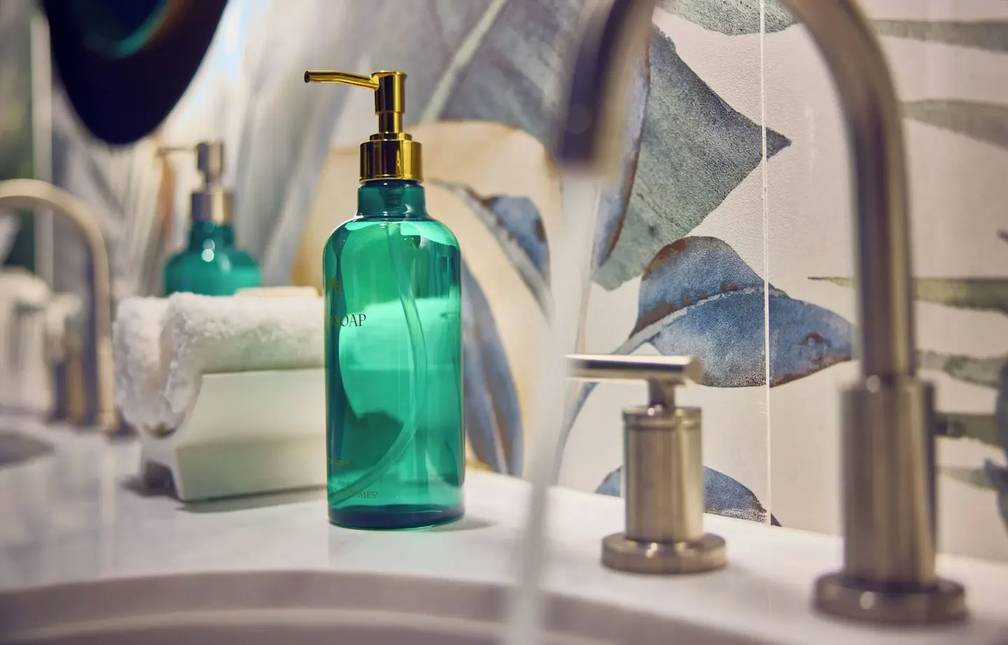 Standard Room sink with teal soap bottle and faucet at British Colonial Nassau.