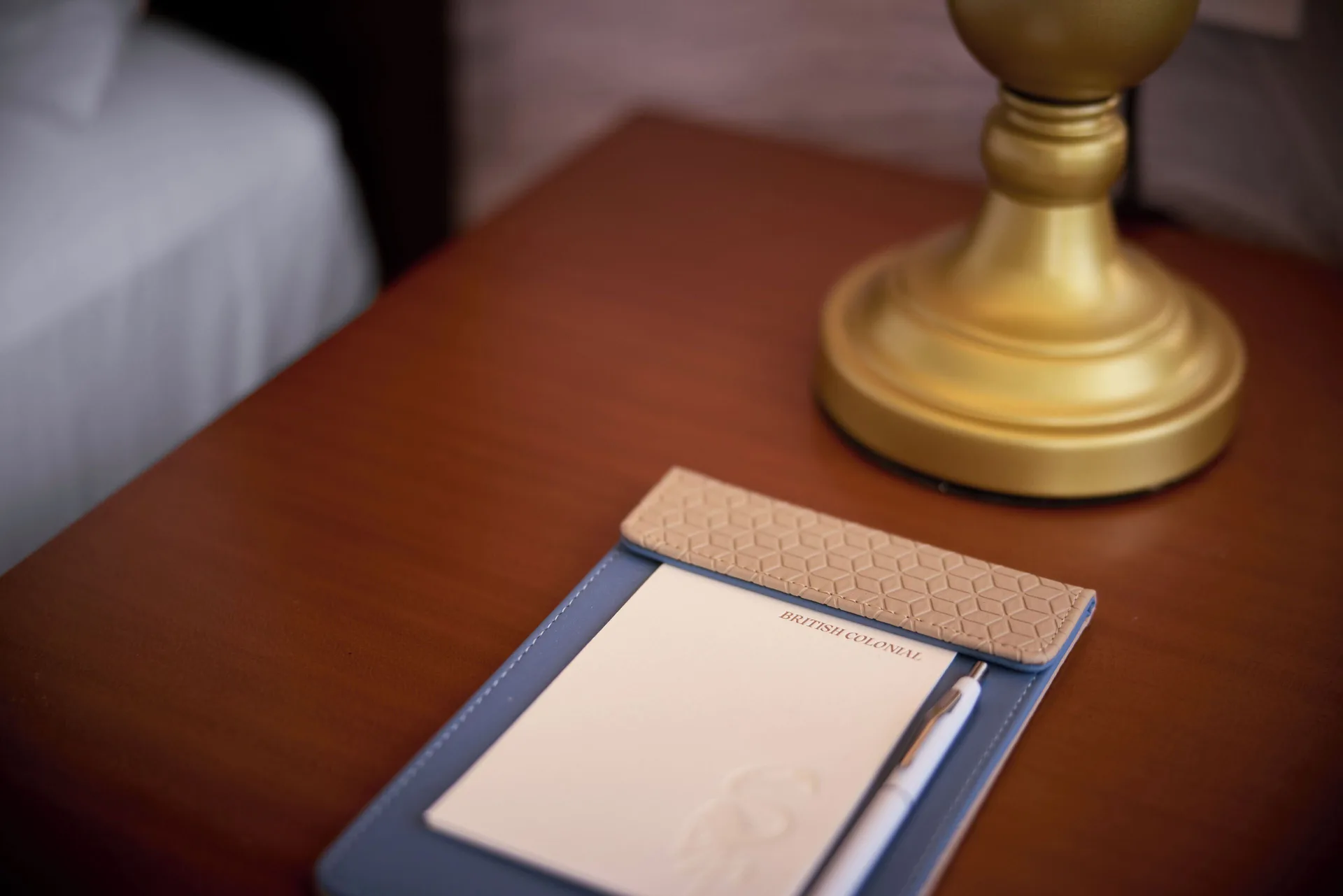 Standard Room bedside notepad and lamp at British Colonial Nassau.