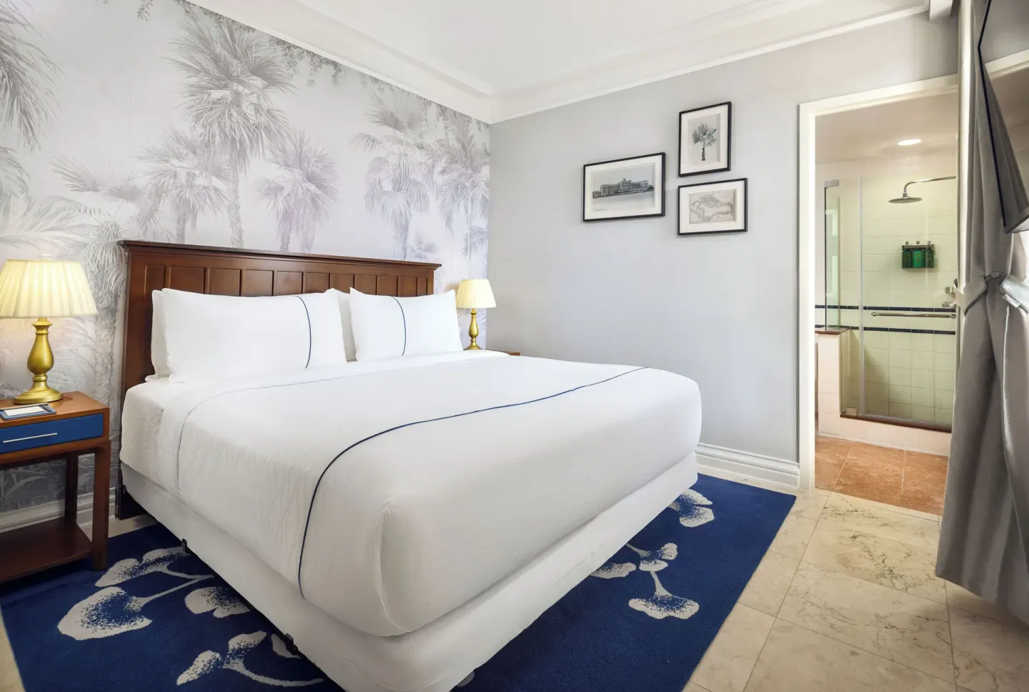Standard Room with king bed and bathroom doorway at British Colonial Nassau.