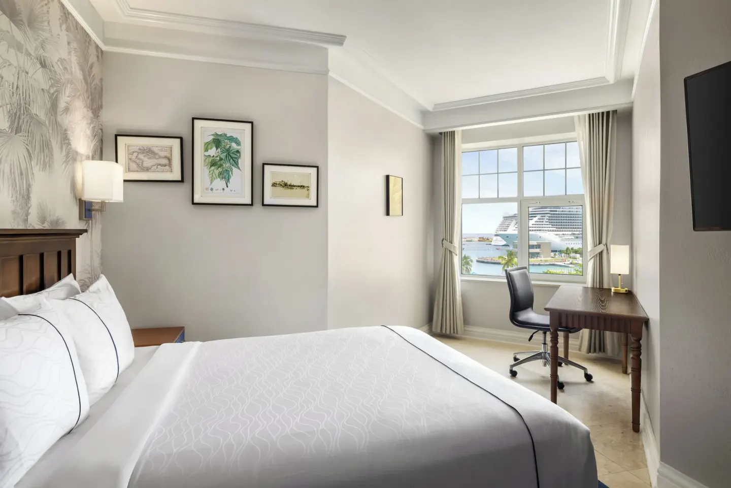 Standard Room king bed and harbor-view desk at British Colonial Nassau.
