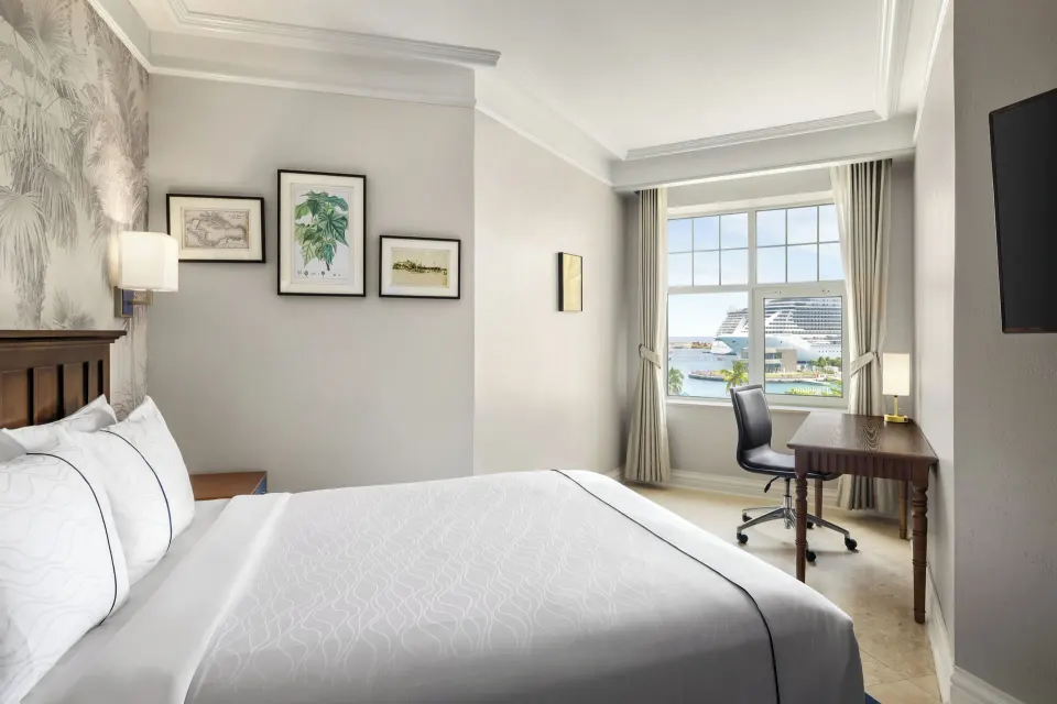 Standard Room king bed and harbor-view desk at British Colonial Nassau.