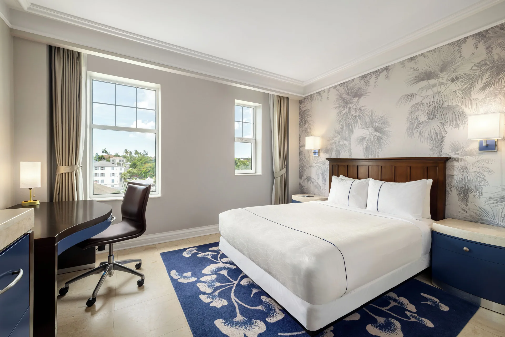Standard Room king bed with desk and two windows at British Colonial Nassau.