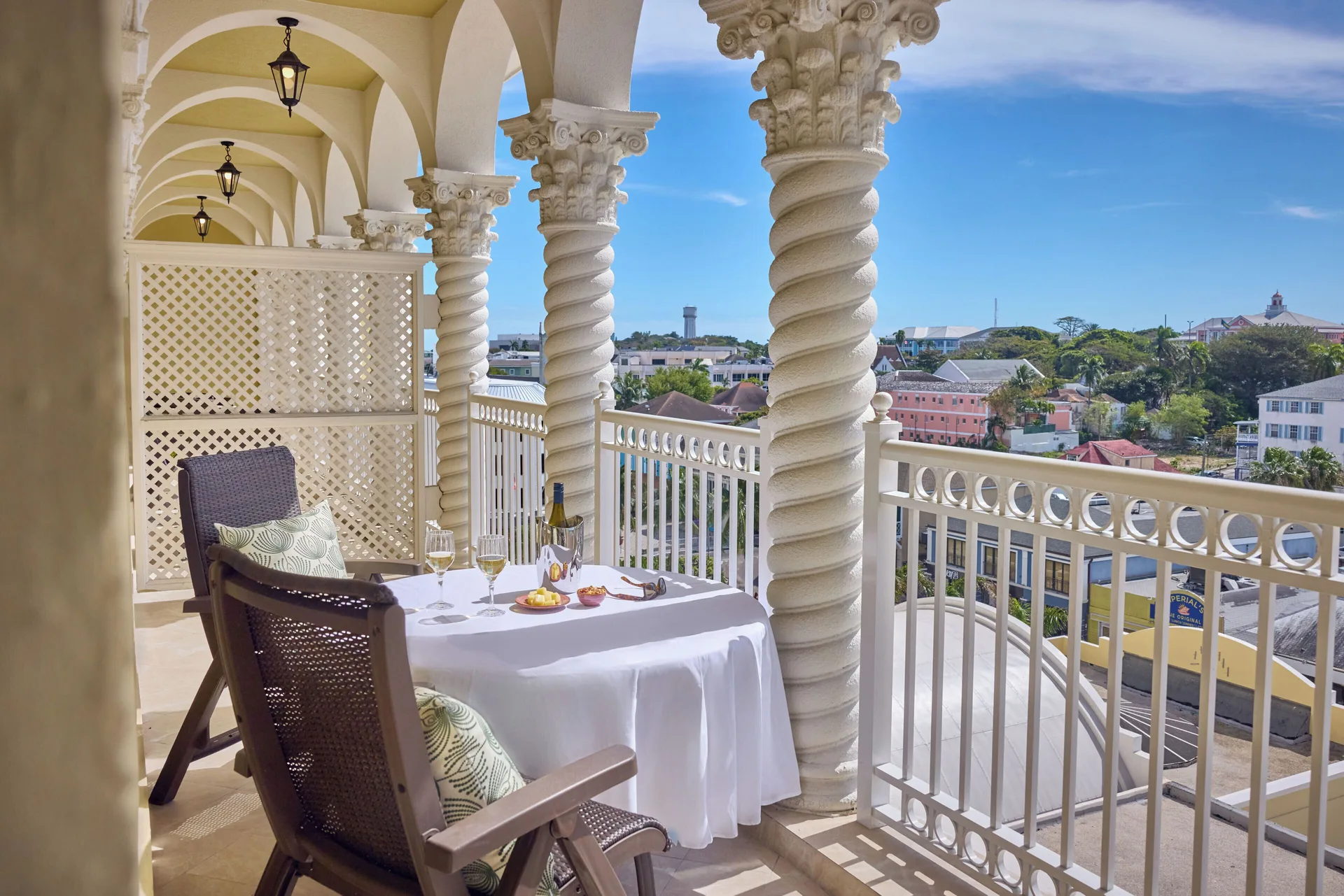 Suite balcony with city view and table setting at British Colonial Nassau.