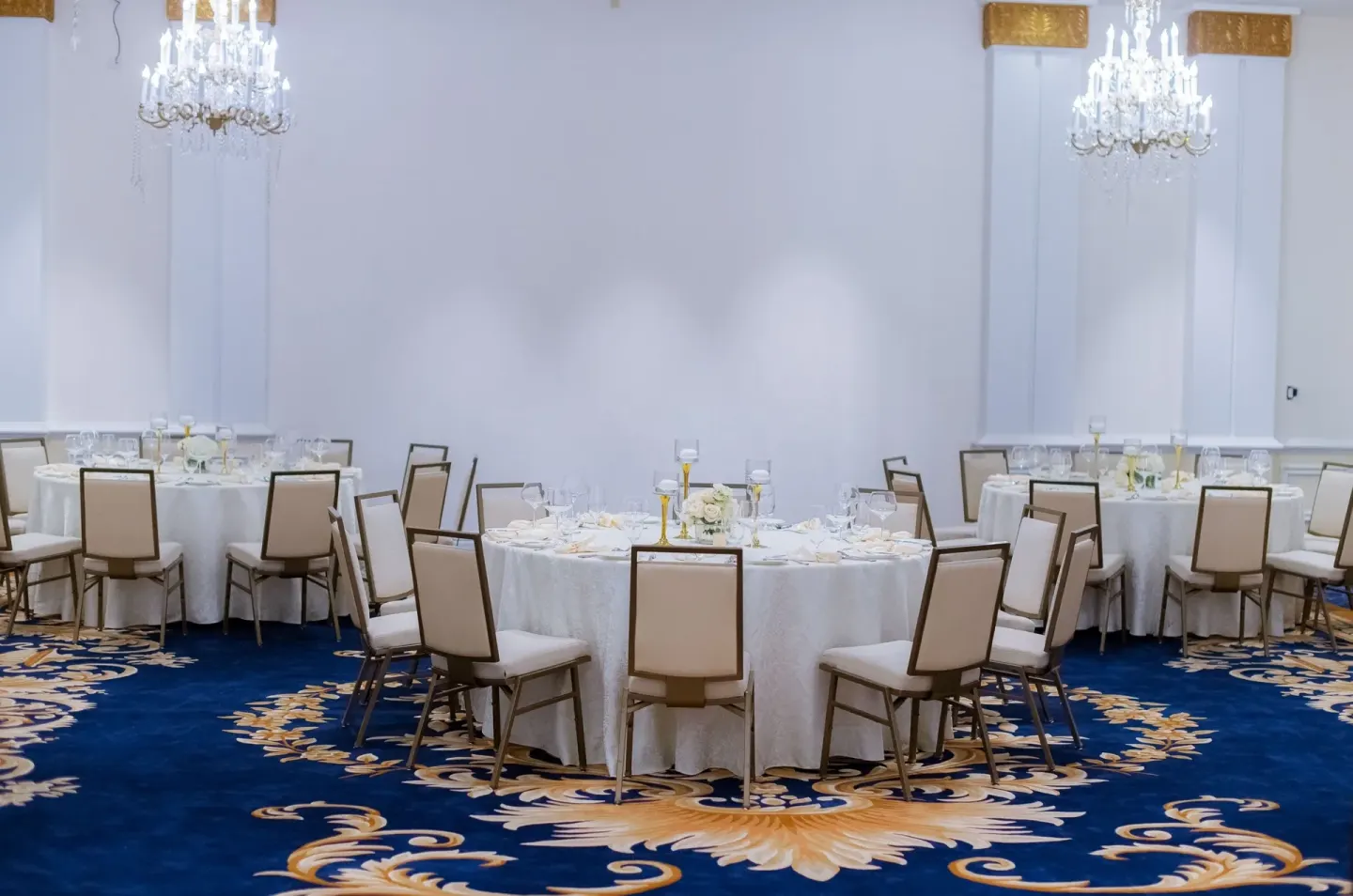Banquet room with round tables and blue carpet at British Colonial Nassau.